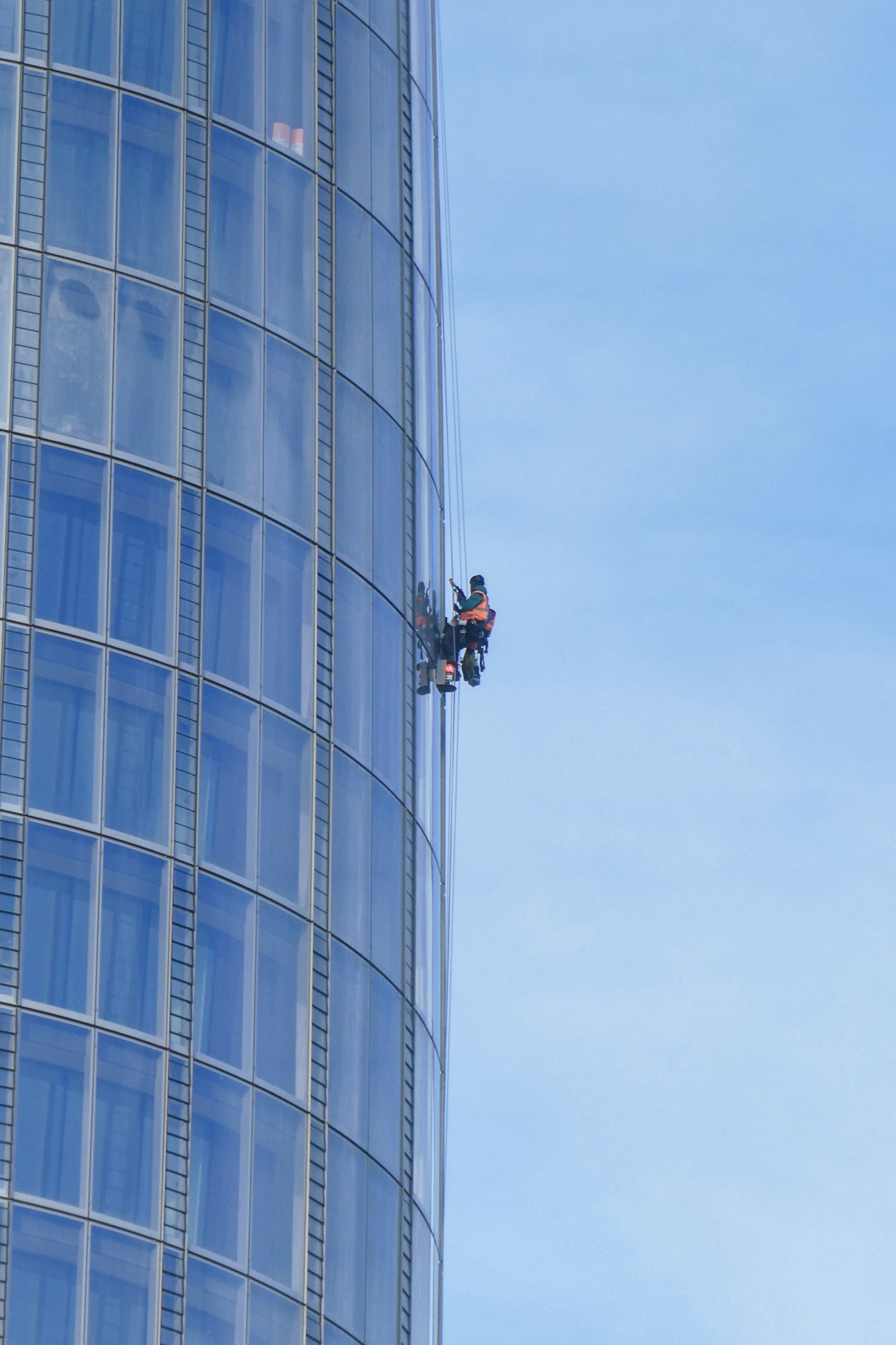 Person cleaning building windows